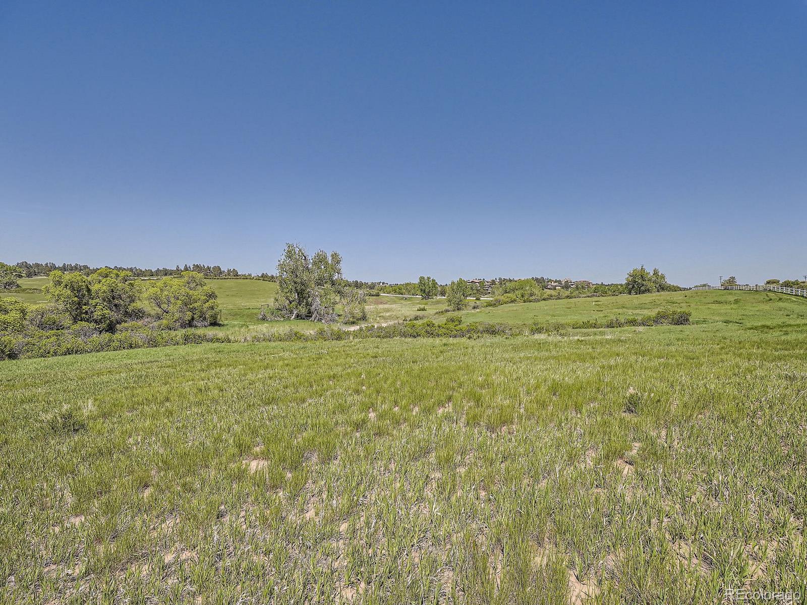 10443 Tomahawk Road Parker, CO 80138 - Photo 14 of 38 a view of a field with an ocean and mountain in the back