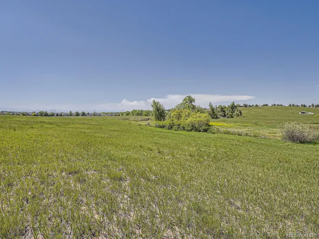 a kitchen with stainless steel appliances granite countertop a stove a sink dishwasher and a refrigerator with wooden floor