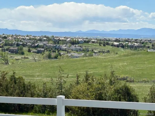 a view of a field with ocean view