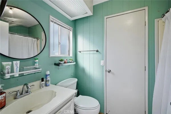 a bathroom with a sink toilet and mirror