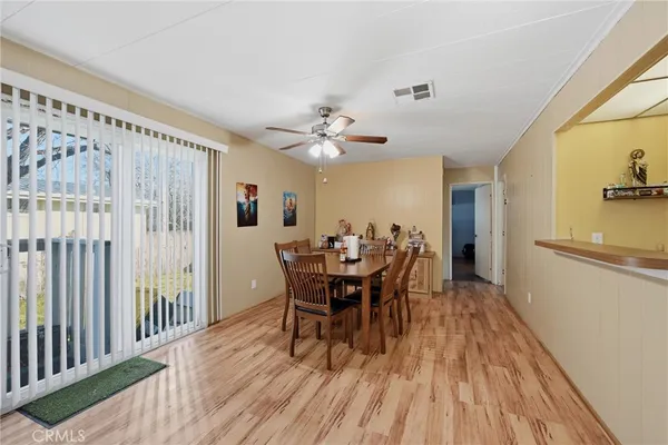 a view of a dining room with furniture and wooden floor