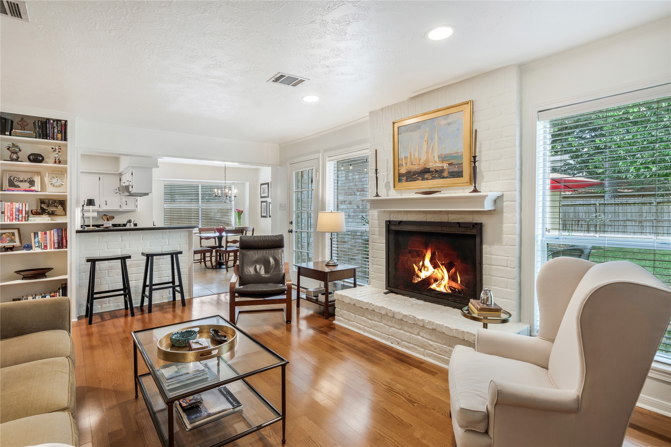 7622 Feliciana Lane Spring, TX 77379 - Photo 11 of 34 a living room with furniture a fireplace a flat screen tv and a large window