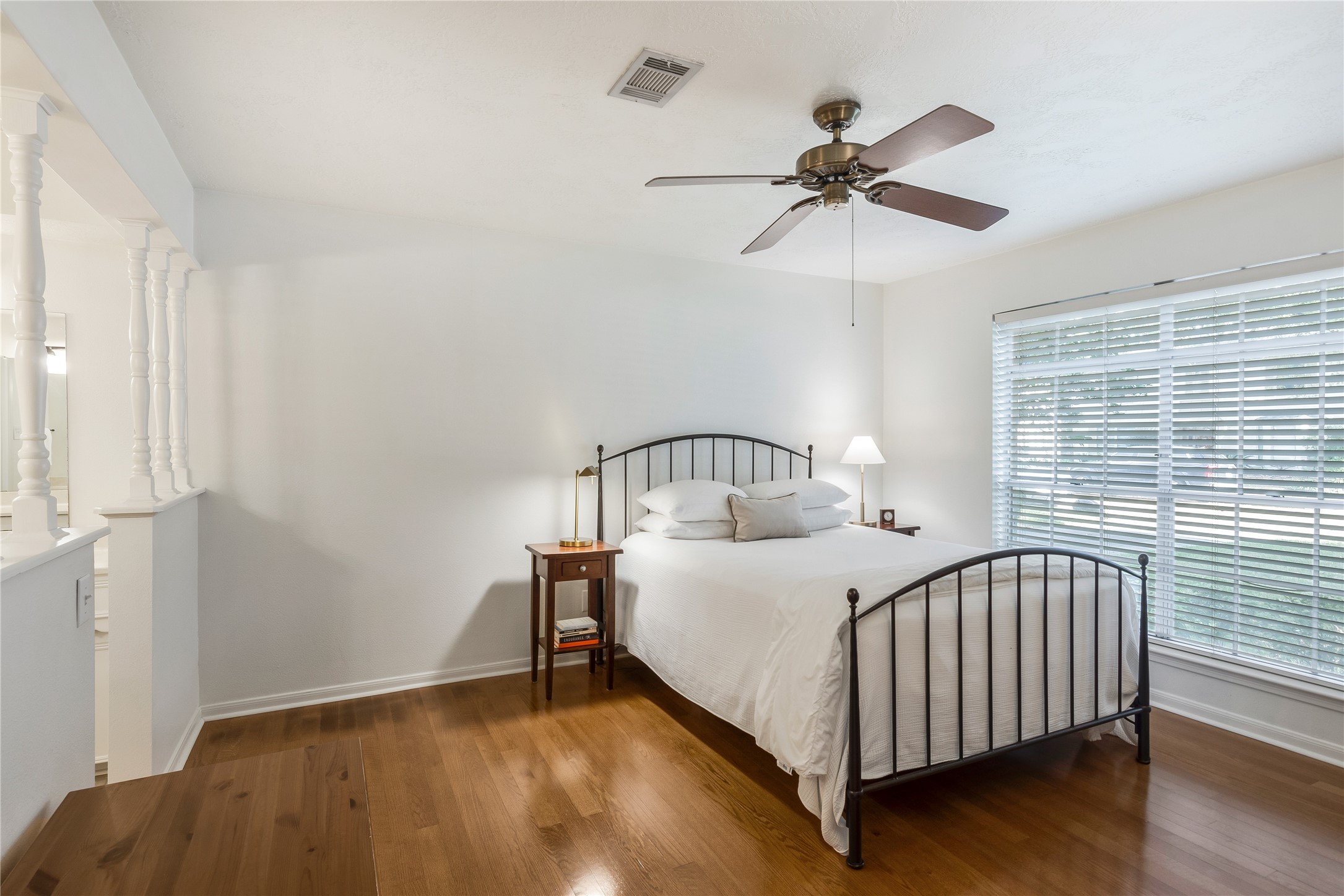 7622 Feliciana Lane Spring, TX 77379 - Photo 18 of 34 a bedroom with a bed and a chandelier