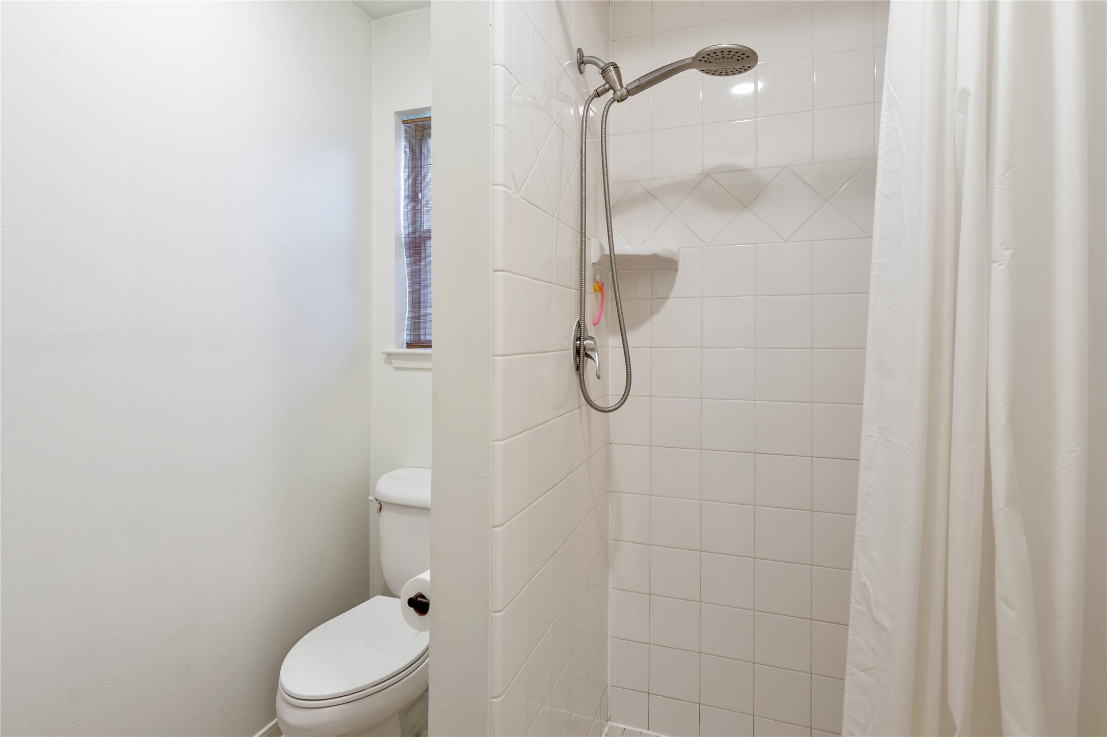 7622 Feliciana Lane Spring, TX 77379 - Photo 23 of 34 a white toilet sitting next to a bathroom sink