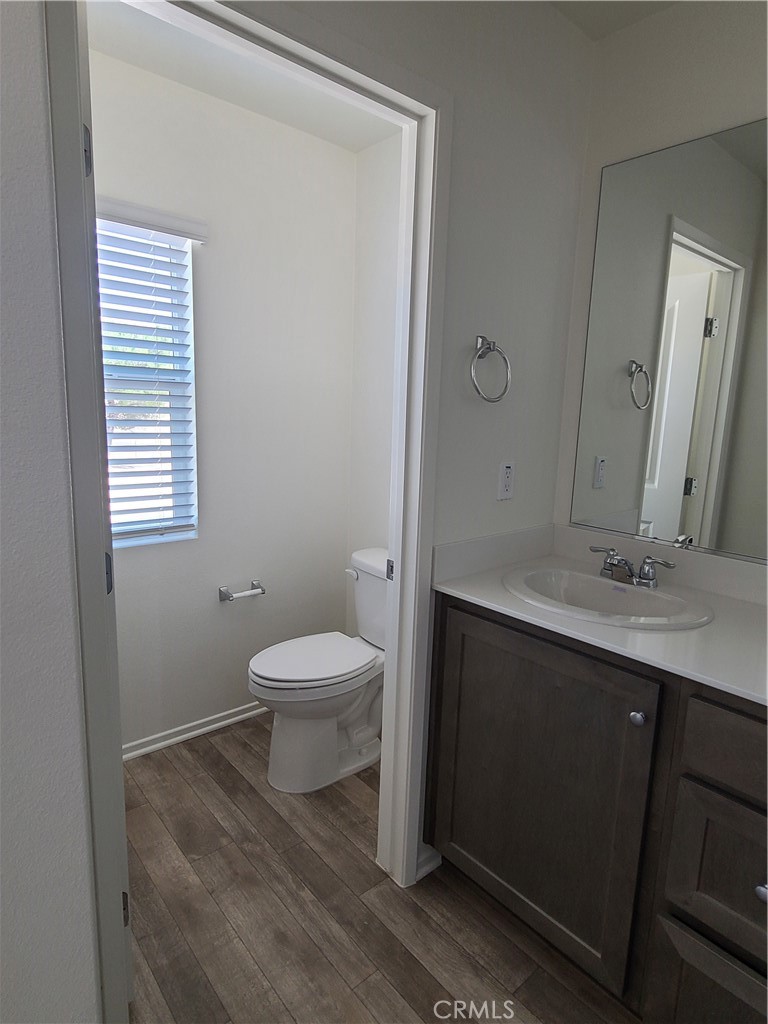 30540 Altima Court Winchester, CA 92596 - Photo 17 of 21 a bathroom with a toilet a sink and mirror