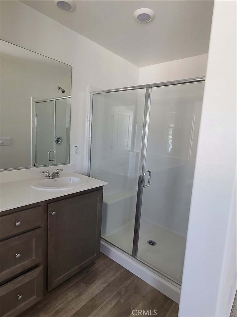 30540 Altima Court Winchester, CA 92596 - Photo 18 of 21 a bathroom with a shower sink and mirror