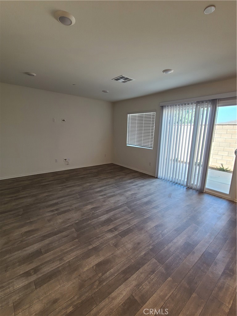 30540 Altima Court Winchester, CA 92596 - Photo 10 of 21 an empty room with wooden floor and windows