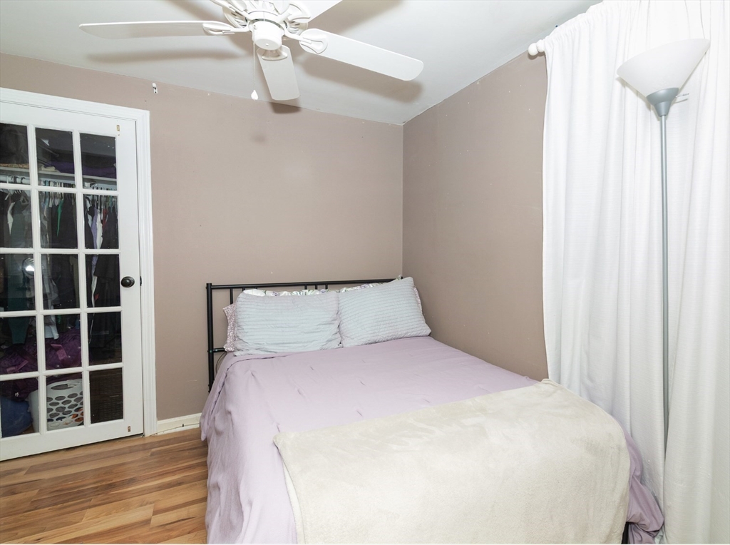 38 Depot Street Milford, MA 01757 - Photo 14 of 34 a large bed sitting in a bedroom next to a window and a ceiling fan