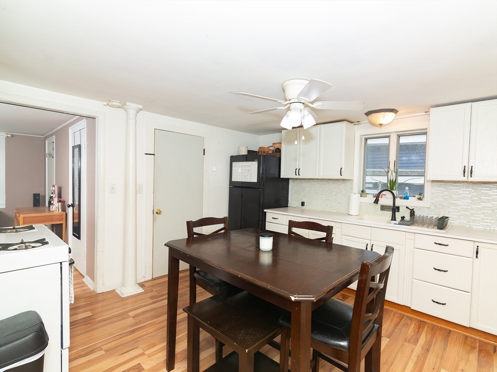 38 Depot Street Milford, MA 01757 - Photo 15 of 34 a kitchen with a table chairs and white cabinets