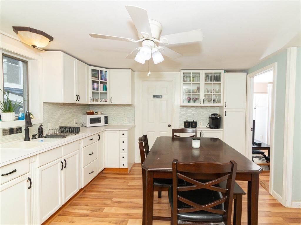 38 Depot Street Milford, MA 01757 - Photo 17 of 34 a kitchen with kitchen island a dining table and chairs