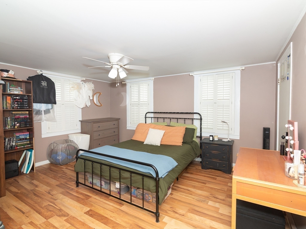 38 Depot Street Milford, MA 01757 - Photo 18 of 34 a bedroom with a bed and a chandelier