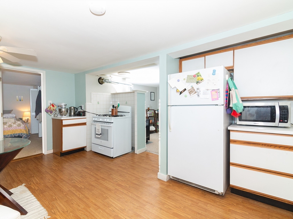 38 Depot Street Milford, MA 01757 - Photo 2 of 34 a kitchen with a refrigerator and white cabinets