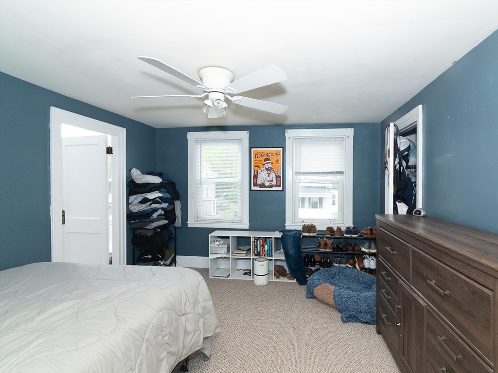 38 Depot Street Milford, MA 01757 - Photo 25 of 34 a bedroom with a bed and a chandelier