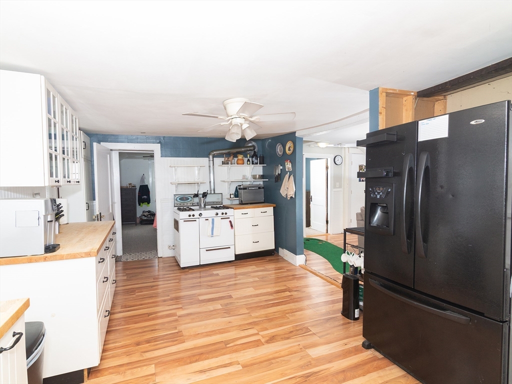38 Depot Street Milford, MA 01757 - Photo 27 of 34 a kitchen with stainless steel appliances kitchen island granite countertop a refrigerator and a sink