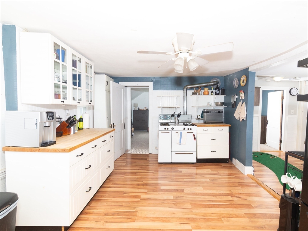 38 Depot Street Milford, MA 01757 - Photo 28 of 34 a large white kitchen with granite countertop a sink and cabinets