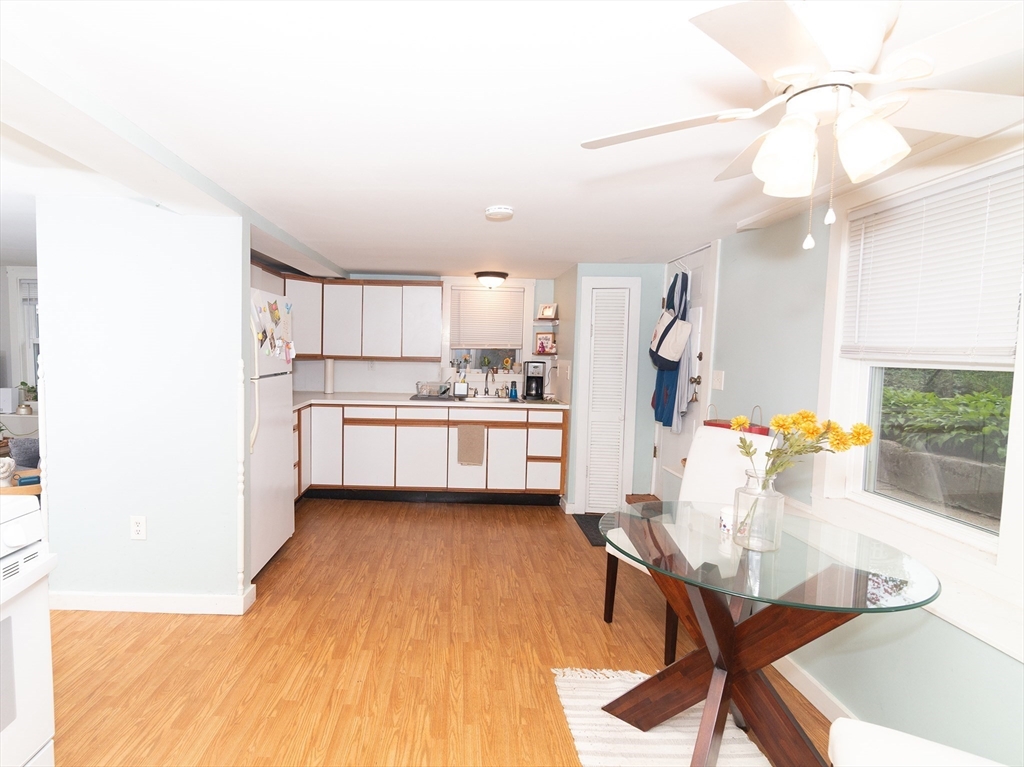 38 Depot Street Milford, MA 01757 - Photo 3 of 34 a kitchen with stainless steel appliances kitchen island granite countertop a refrigerator a stove a sink dishwasher and white cabinets with wooden floor