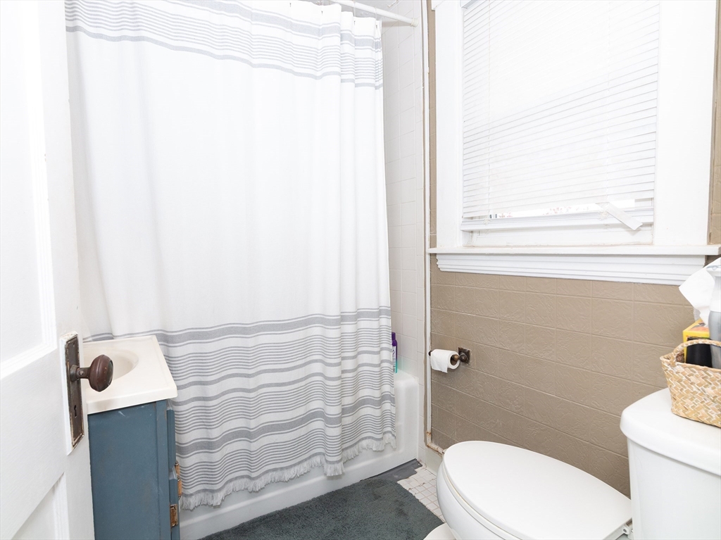 38 Depot Street Milford, MA 01757 - Photo 33 of 34 a bathroom with a toilet and a shower curtain