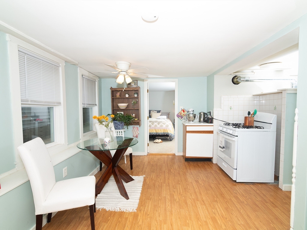 38 Depot Street Milford, MA 01757 - Photo 4 of 34 a kitchen with white cabinets and chairs