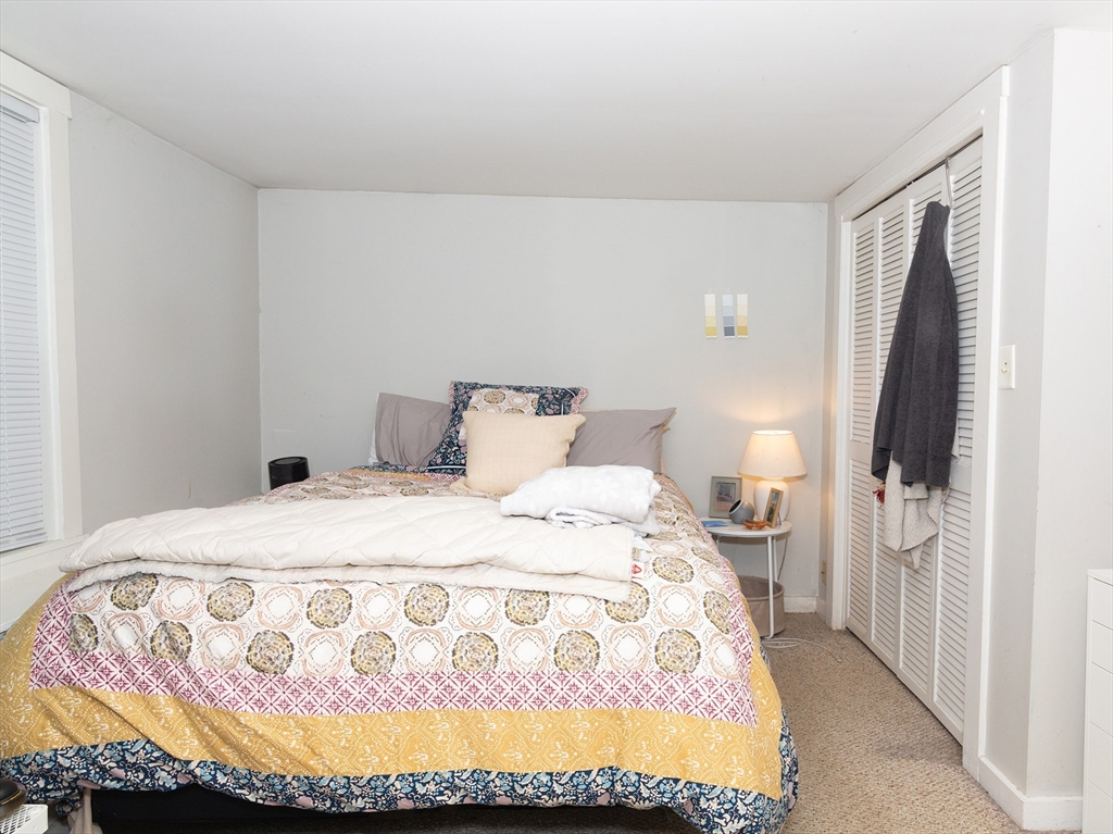 38 Depot Street Milford, MA 01757 - Photo 8 of 34 a bedroom with a bed and flat screen tv