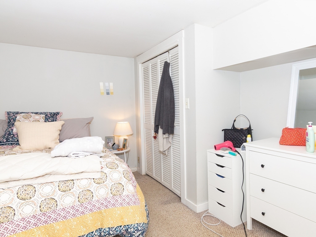 38 Depot Street Milford, MA 01757 - Photo 9 of 34 a bedroom with a bed and cabinets