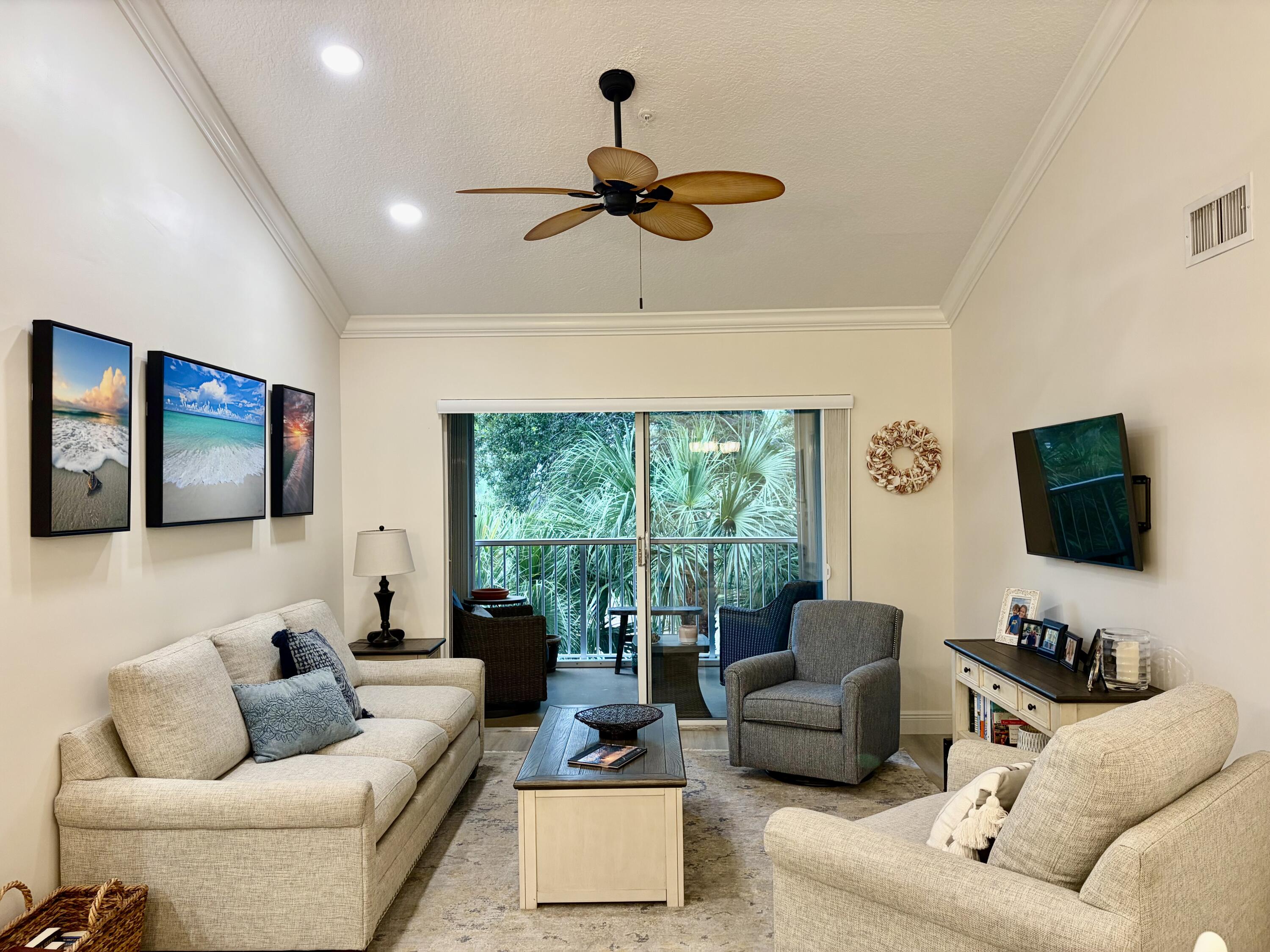 242 Village Boulevard, Unit 2304 Tequesta, FL 33469 - Photo 12 of 34 a living room with furniture and a flat screen tv