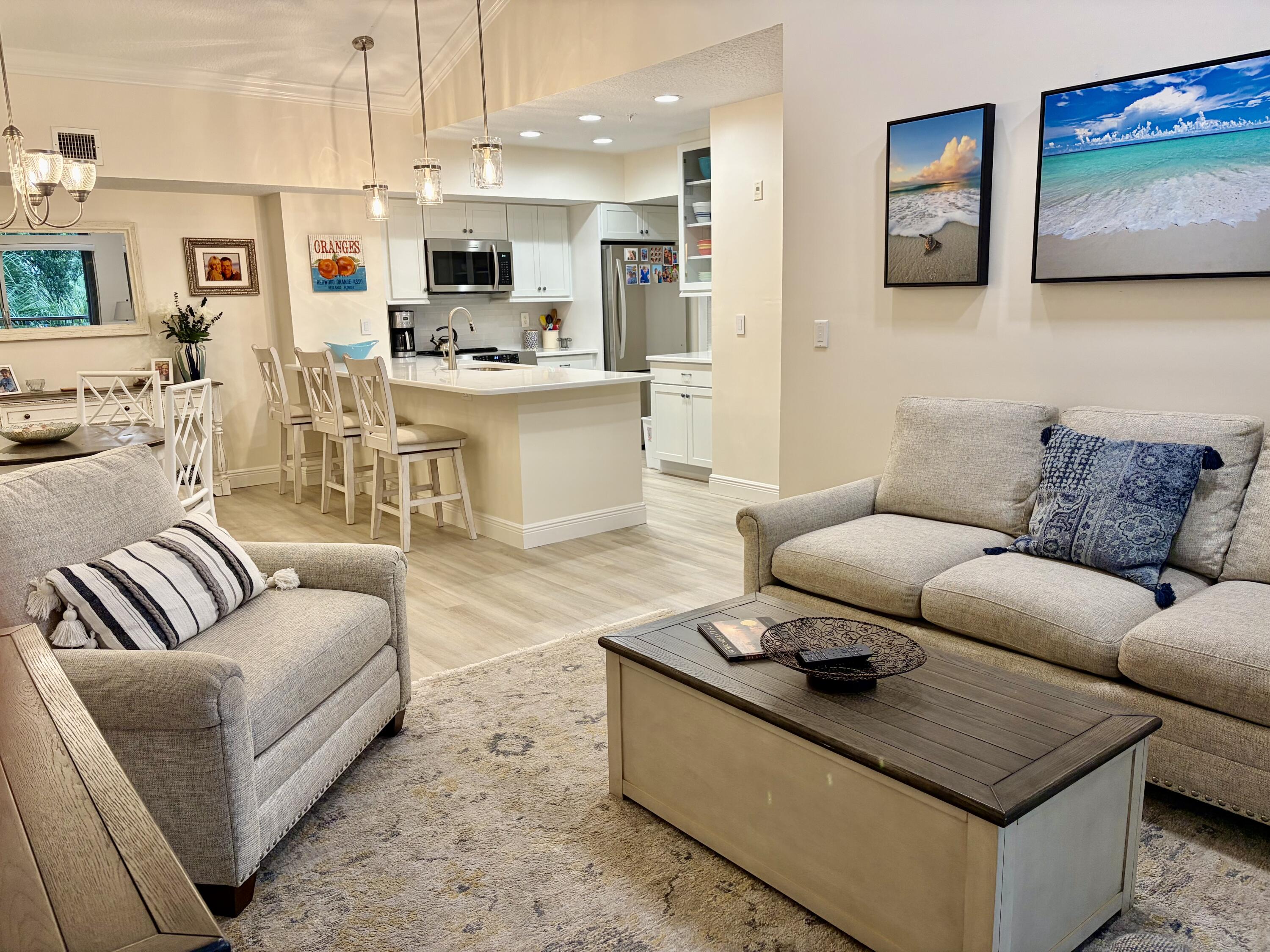 242 Village Boulevard, Unit 2304 Tequesta, FL 33469 - Photo 13 of 34 a living room with furniture kitchen view and a flat screen tv