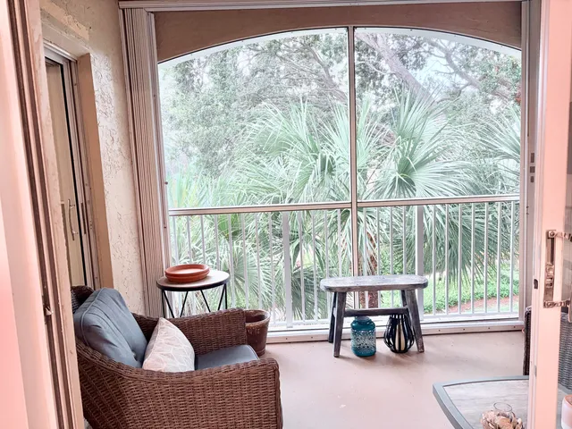 a living room with furniture and a floor to ceiling window