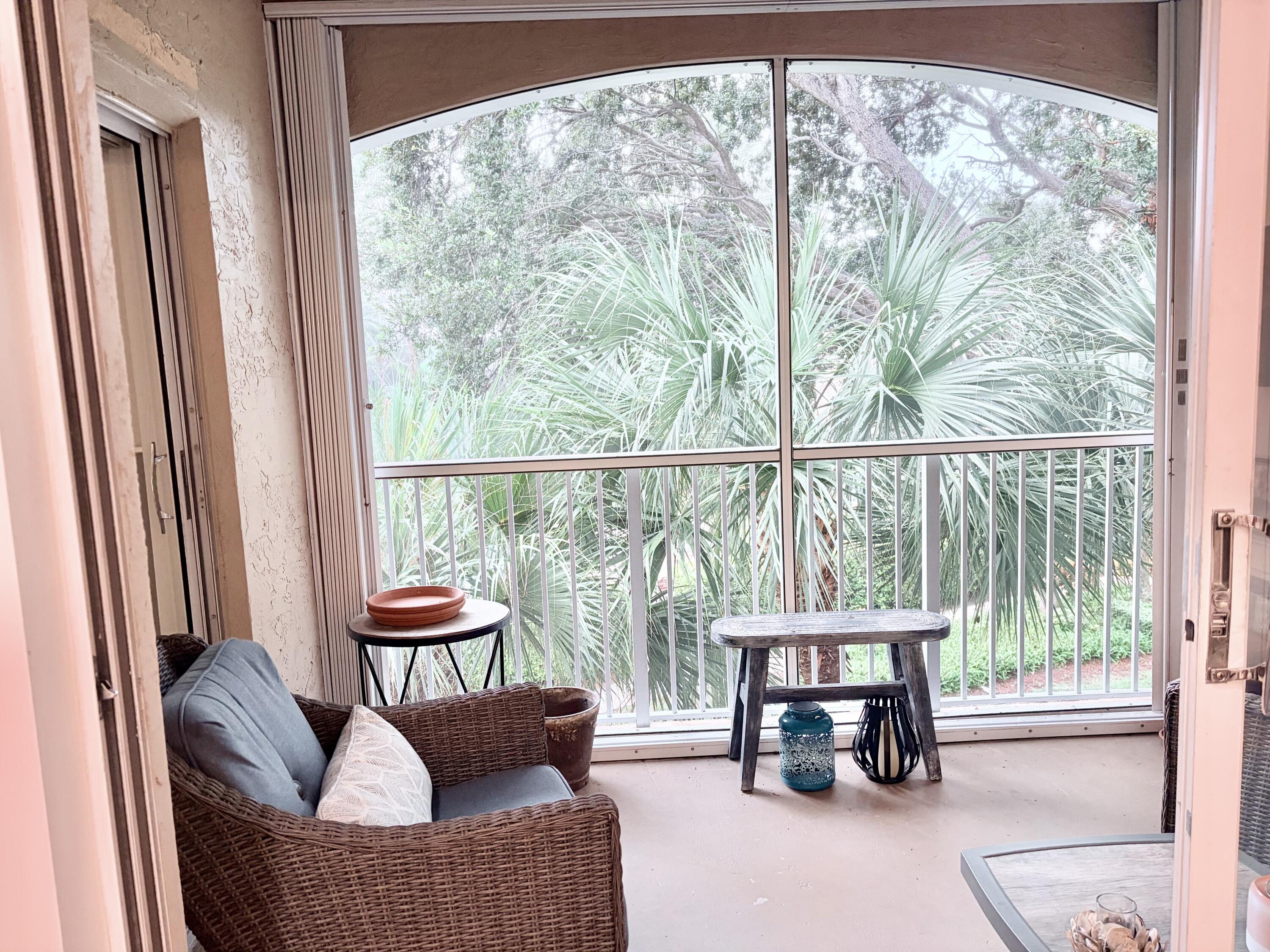 242 Village Boulevard, Unit 2304 Tequesta, FL 33469 - Photo 14 of 34 a living room with furniture and a floor to ceiling window