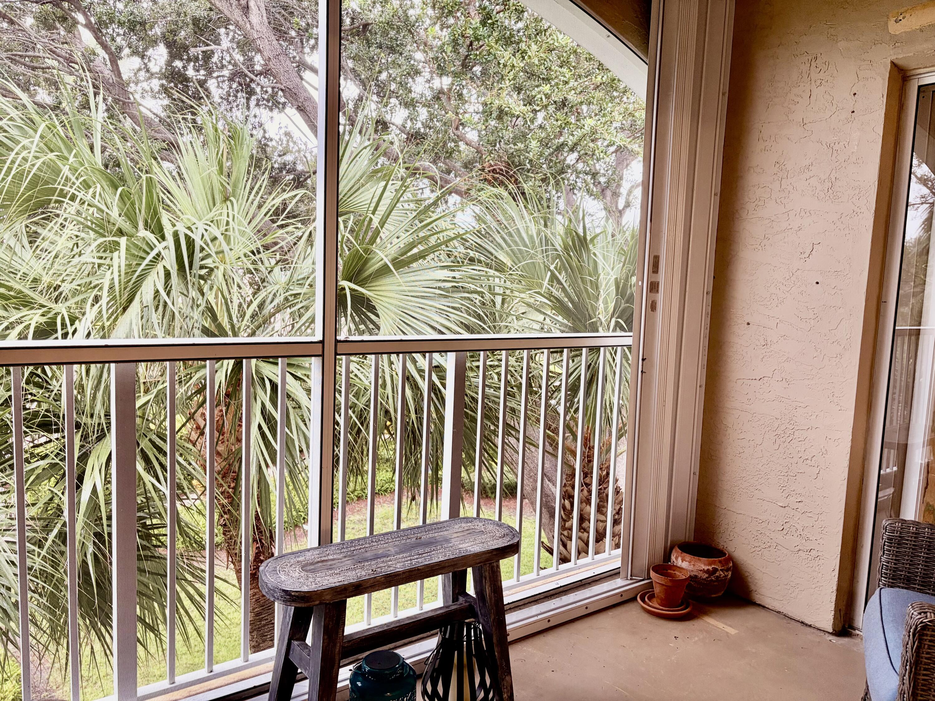 242 Village Boulevard, Unit 2304 Tequesta, FL 33469 - Photo 17 of 34 a view of a porch with furniture and a window
