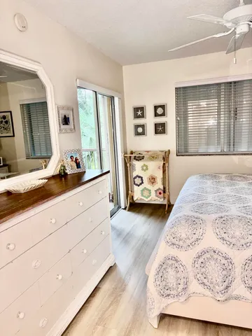 a spacious bedroom with a bed and a large mirror