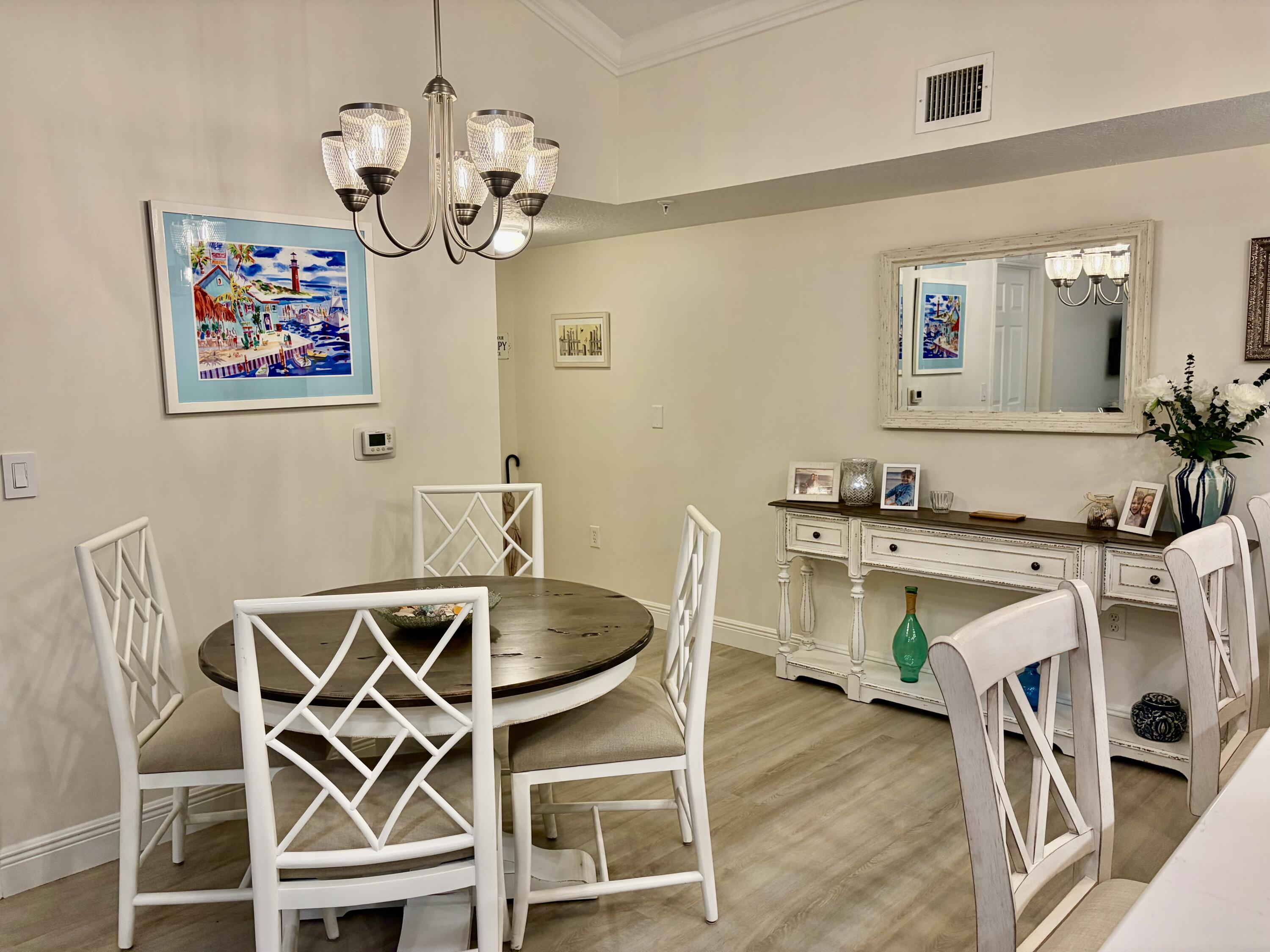 242 Village Boulevard, Unit 2304 Tequesta, FL 33469 - Photo 2 of 34 a dining room with furniture and chandelier