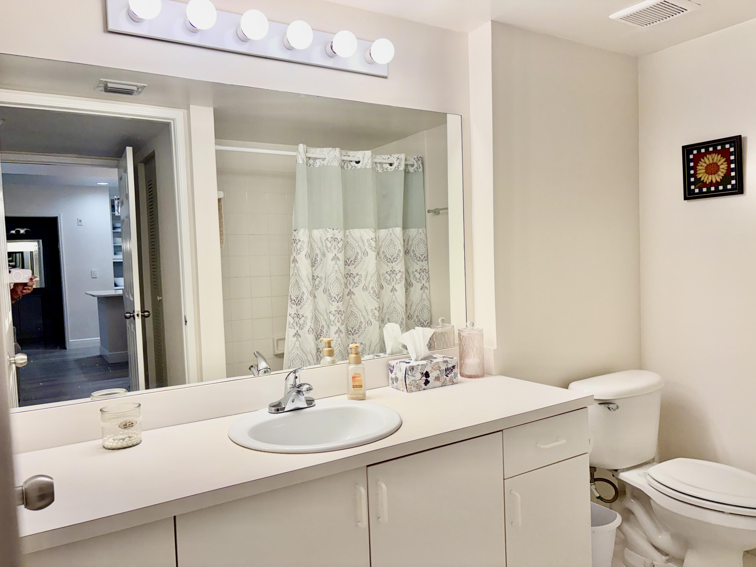 242 Village Boulevard, Unit 2304 Tequesta, FL 33469 - Photo 21 of 34 a bathroom with a sink and a mirror