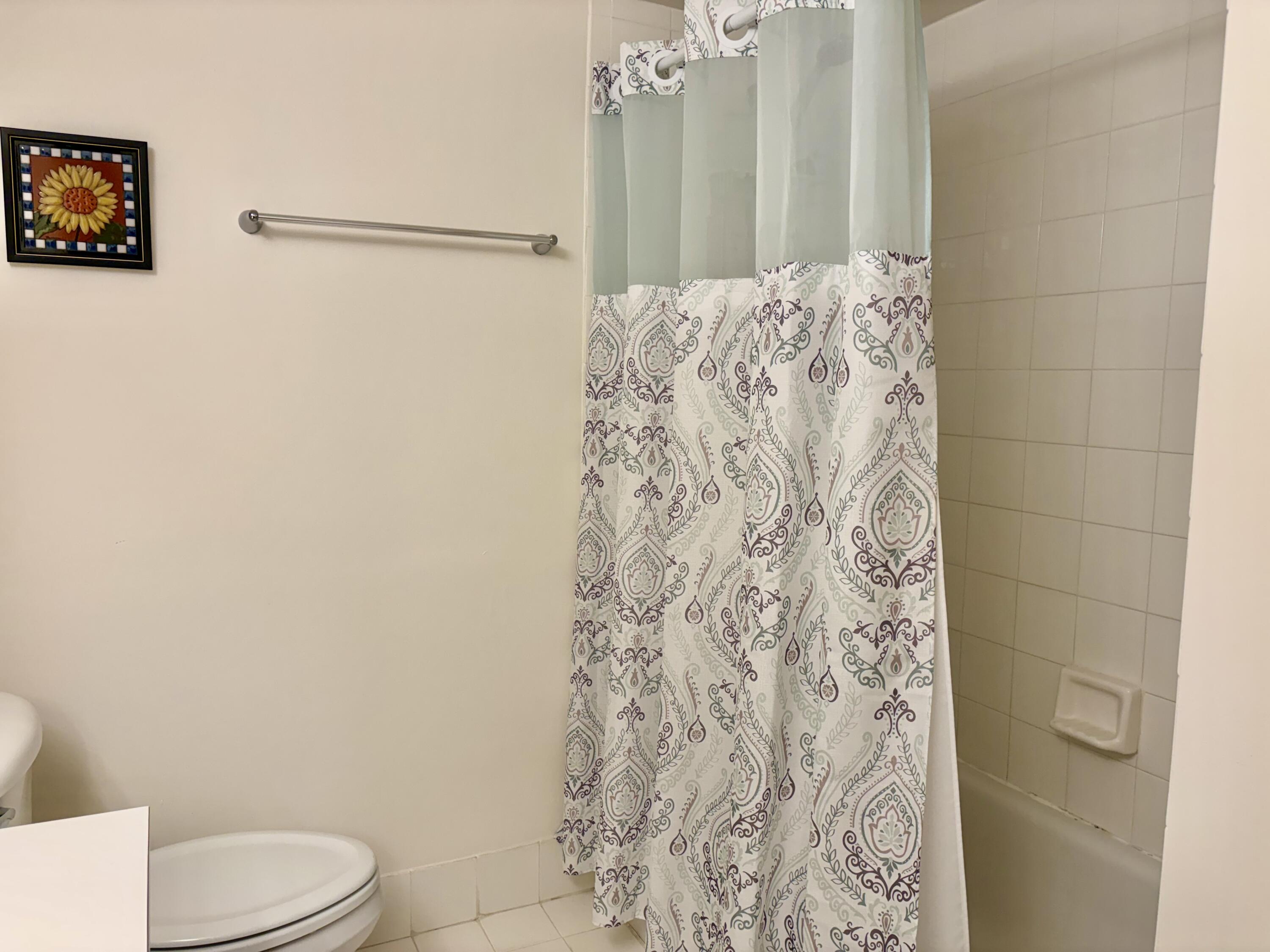242 Village Boulevard, Unit 2304 Tequesta, FL 33469 - Photo 22 of 34 a bathroom with a toilet and shower