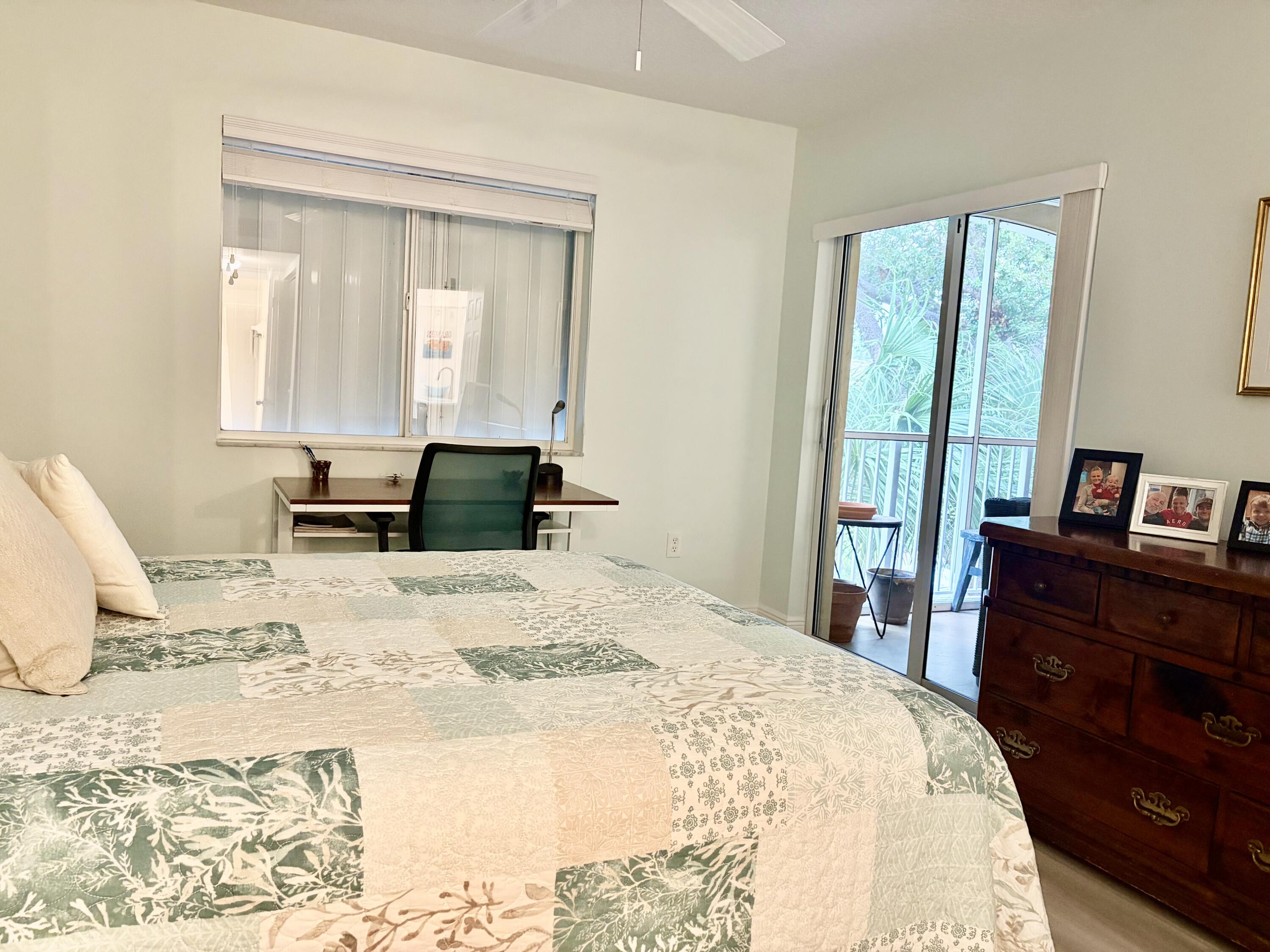 242 Village Boulevard, Unit 2304 Tequesta, FL 33469 - Photo 24 of 34 a bedroom with a bed and wooden floor