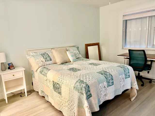 a bedroom with a bed and a window