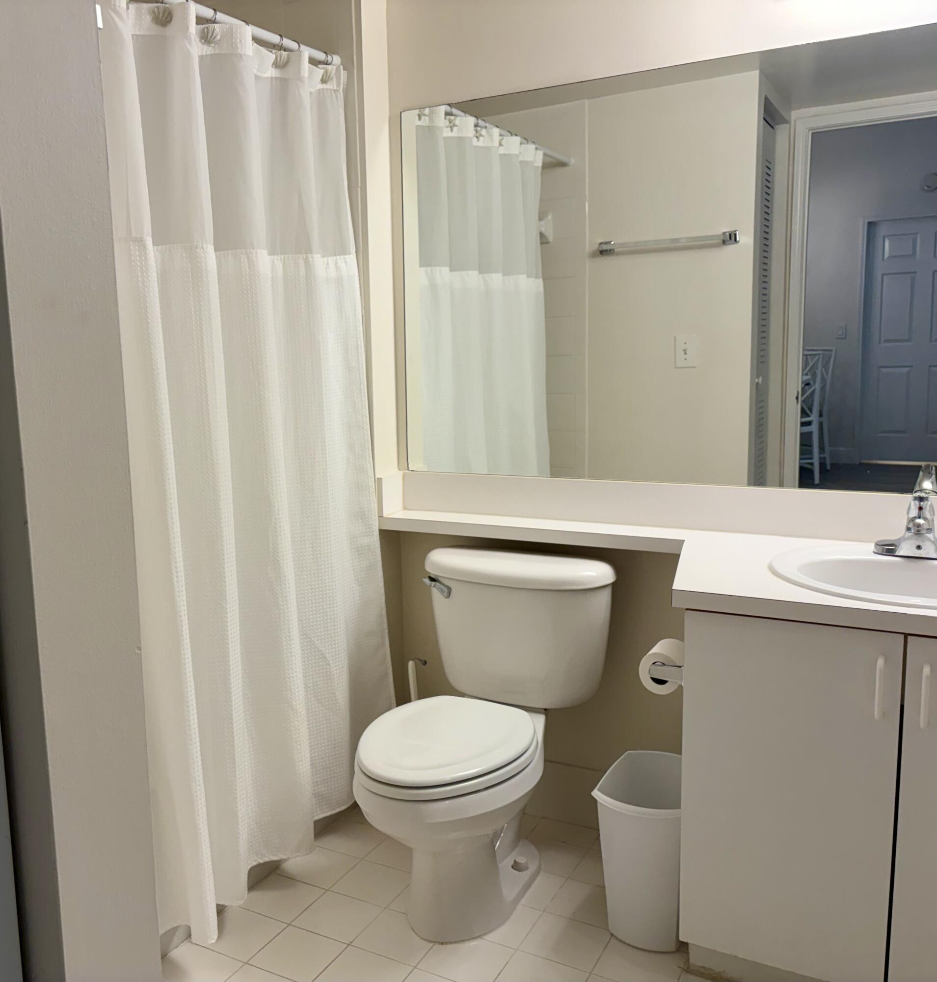 242 Village Boulevard, Unit 2304 Tequesta, FL 33469 - Photo 28 of 34 a bathroom with a toilet a sink and a shower