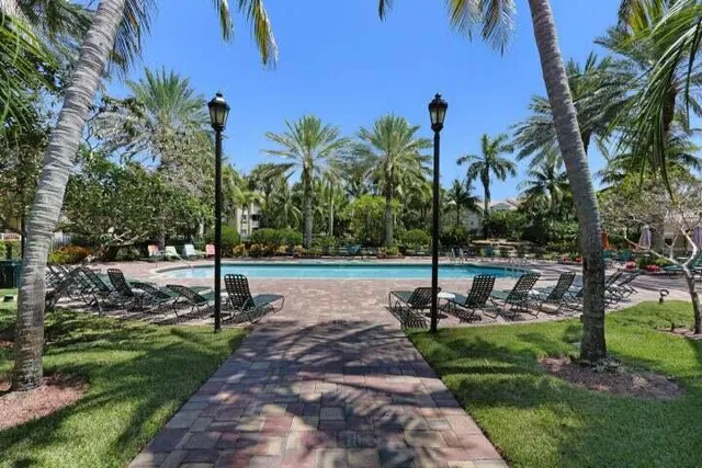 a swimming pool with outdoor seating