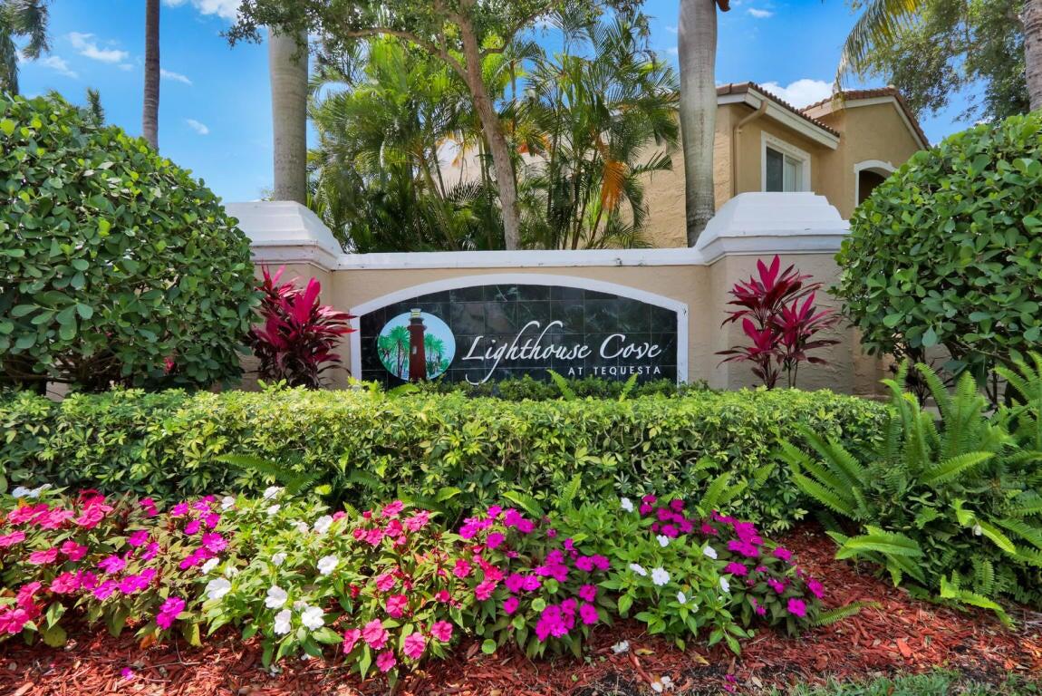 242 Village Boulevard, Unit 2304 Tequesta, FL 33469 - Photo 31 of 34 a sign that is in front of flowers