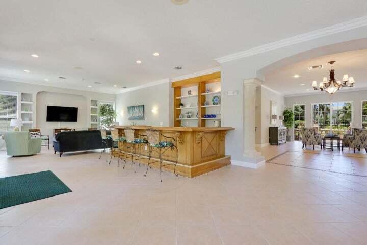 242 Village Boulevard, Unit 2304 Tequesta, FL 33469 - Photo 32 of 34 a living room with furniture and a flat screen tv