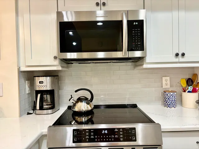 a kitchen with a stove and a microwave