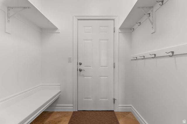 439 East 13540 South Draper, UT 84020 - Photo 13 of 46 Entryway featuring a paneled door with brushed nickel hardware, built-in bench seating, an upper storage shelf with brackets, a wall-mounted coat rack with multiple hooks, and tile flooring