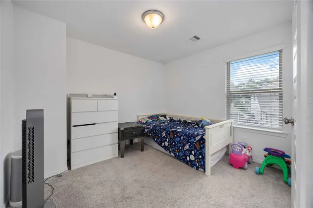 a bed room with bed and window