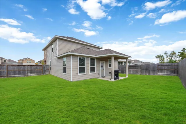a view of a house with a yard and sitting area