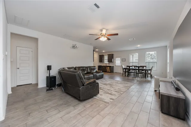 a living room with furniture and kitchen view
