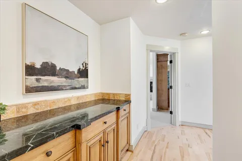 a view of a kitchen with a sink and a wooden floor