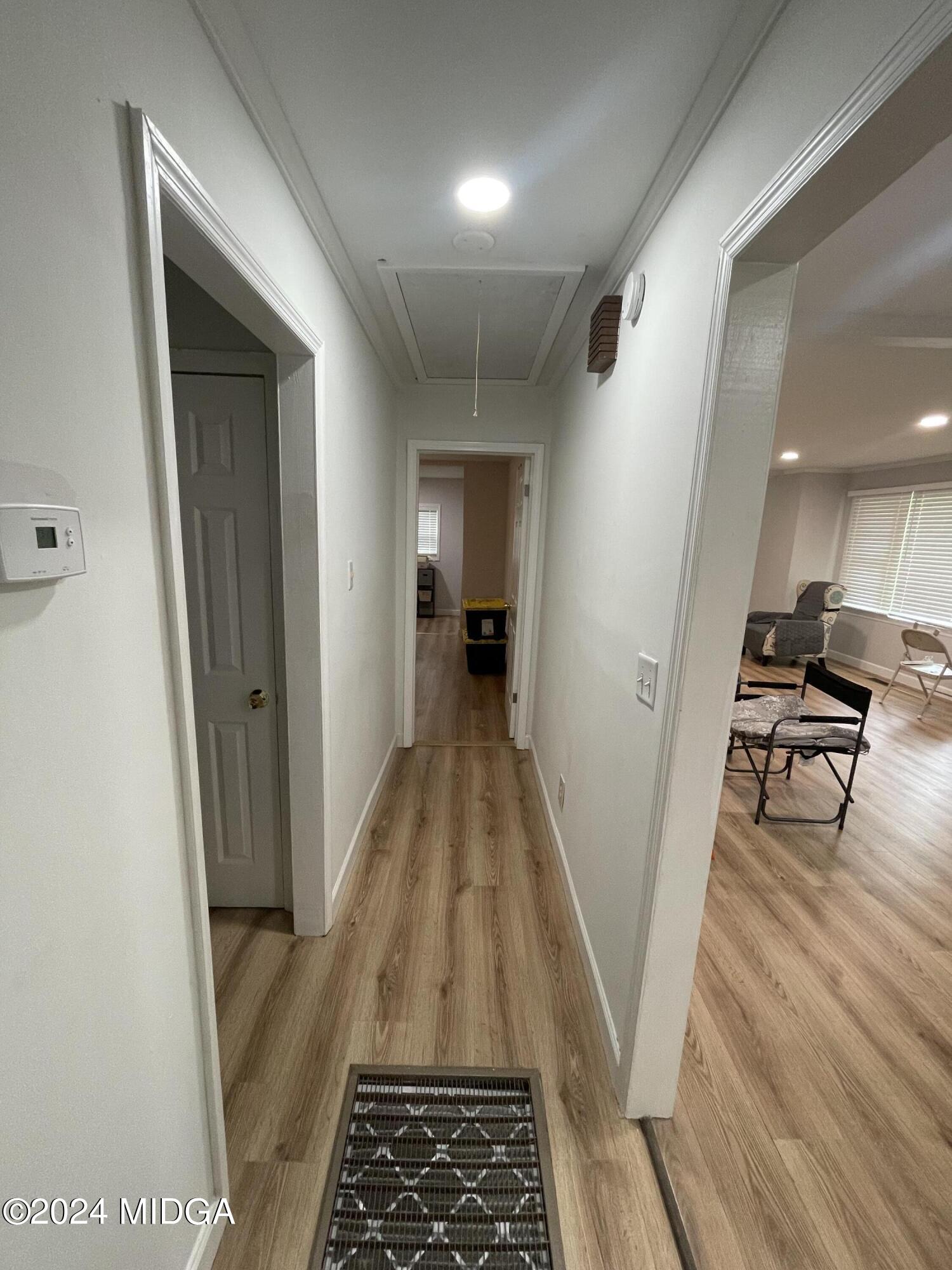 4064 Emory Drive Macon, GA 31206 - Photo 17 of 37 a view of a hallway with wooden floor and furniture