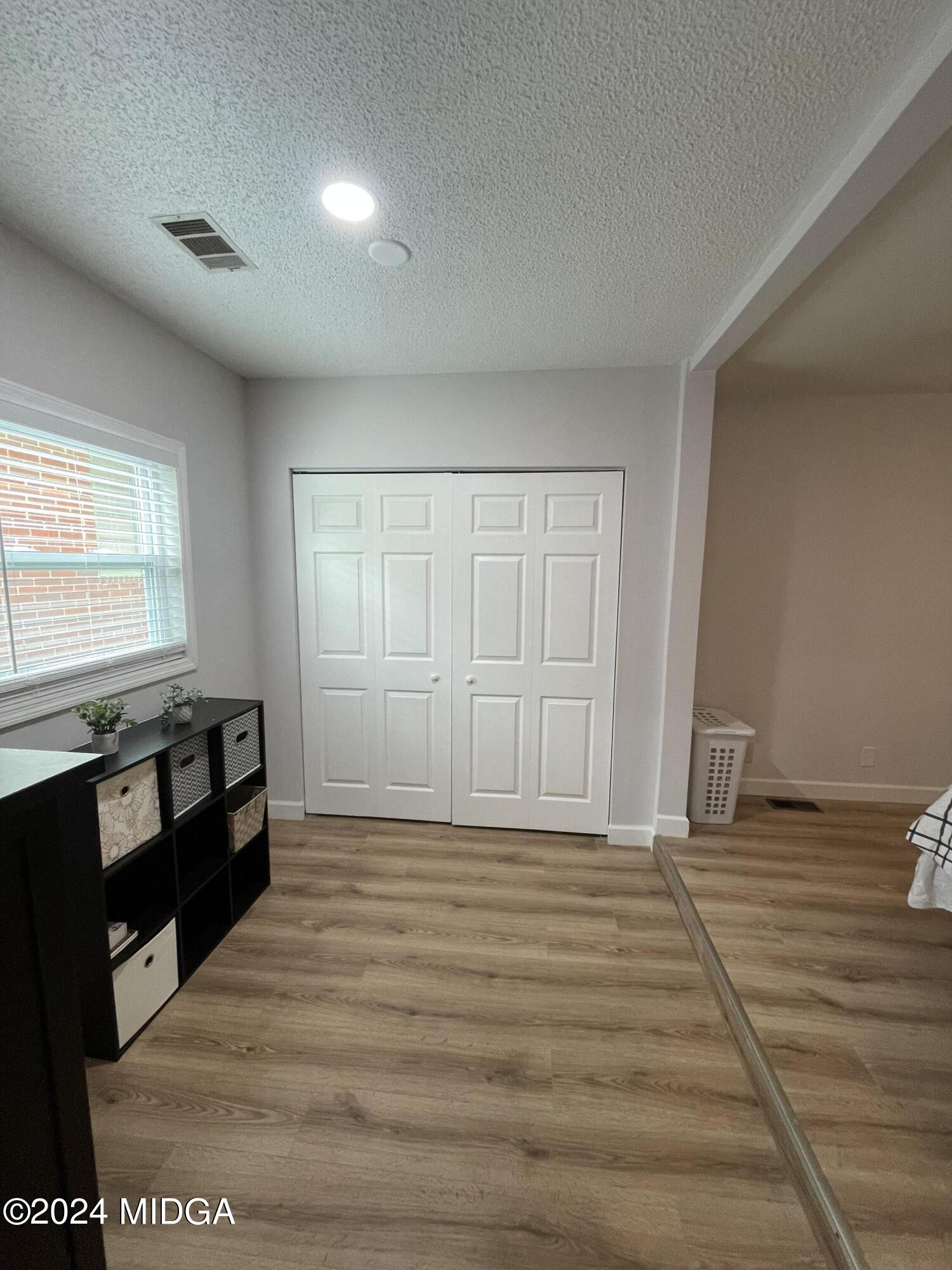 4064 Emory Drive Macon, GA 31206 - Photo 19 of 37 a view of empty room with wooden floor