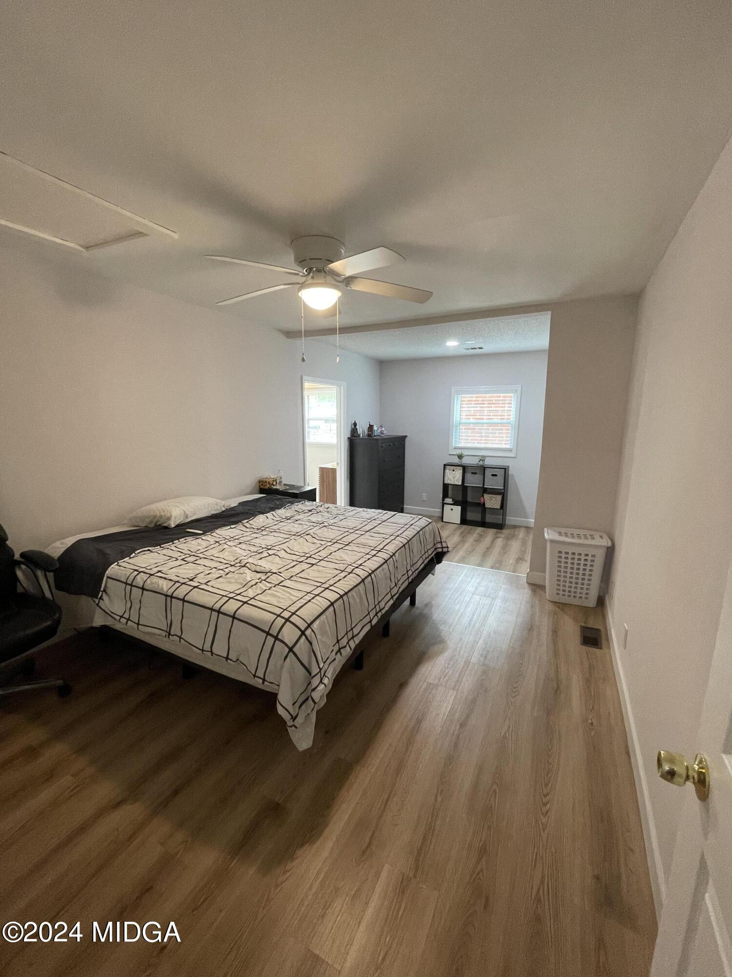 4064 Emory Drive Macon, GA 31206 - Photo 20 of 37 a bedroom with a bed and wooden floor