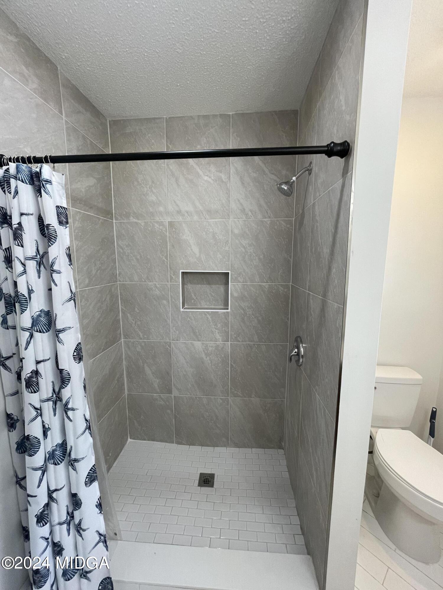 4064 Emory Drive Macon, GA 31206 - Photo 22 of 37 a bathroom with a shower and a toilet