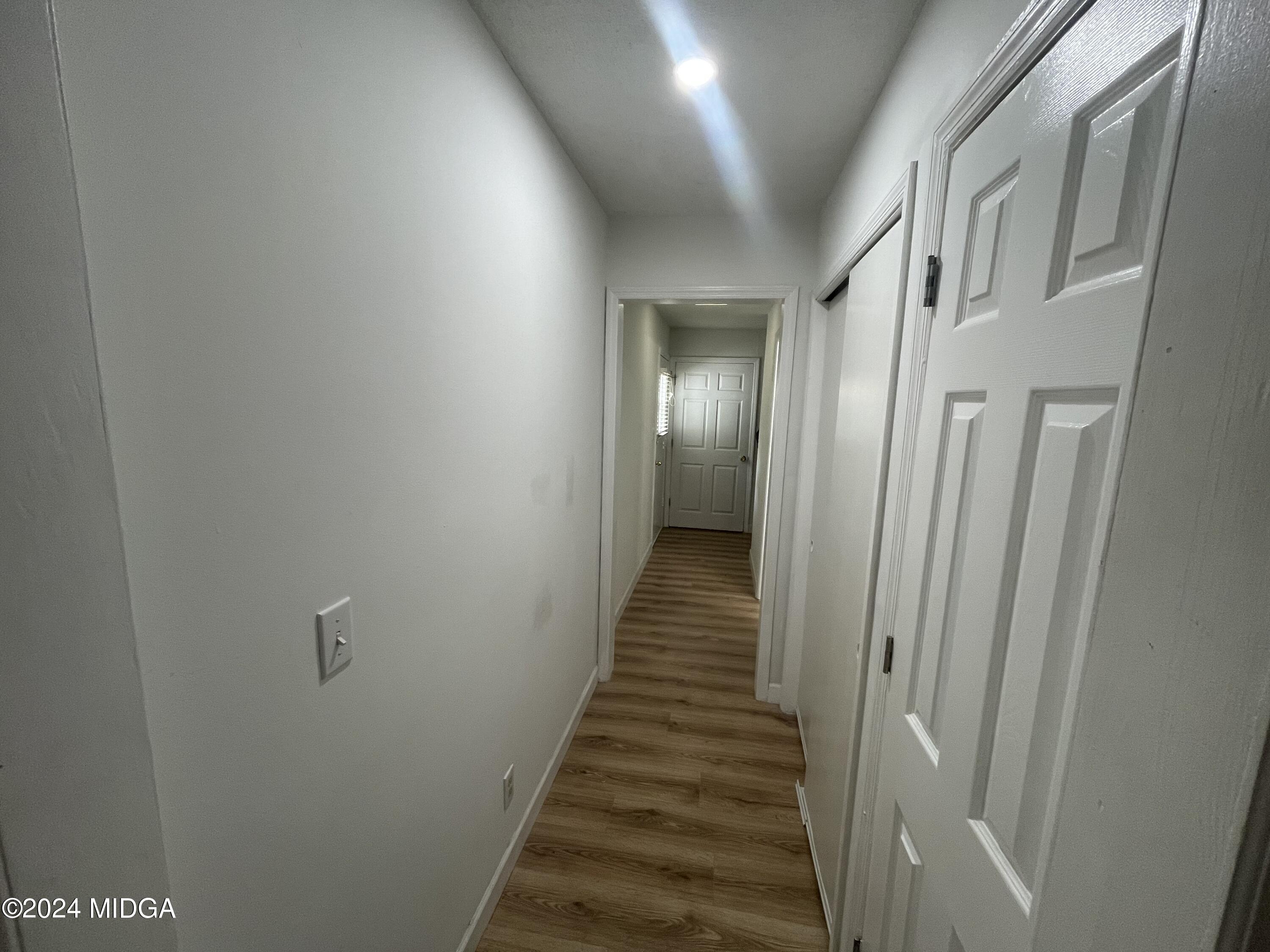 4064 Emory Drive Macon, GA 31206 - Photo 25 of 37 a view of a hallway with wooden floor and staircase